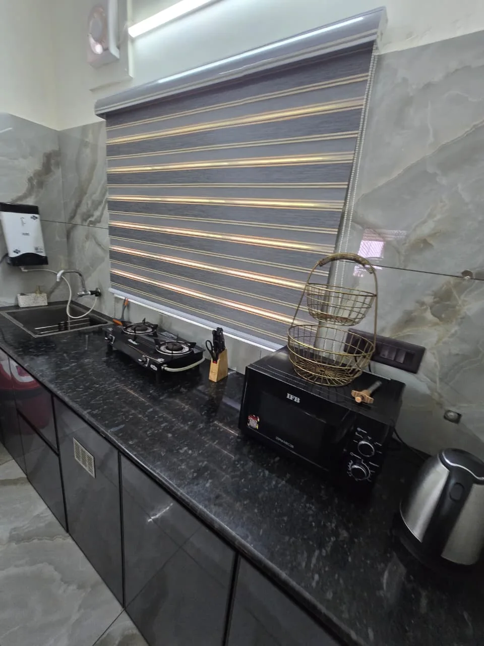 Kitchen counter with cooking appliances at Grey Oasis Homestay in Thrissur
